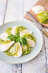 Caprese with green tomatoes and basil