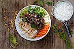 A Thai bowl with rice noodles, vegetables and peanuts