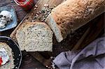 A sliced loaf of homemade wholegrain bread