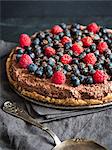 Raw vegan gluten-free chocolate tart with berries