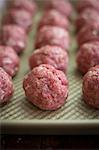 Rows of raw meatballs