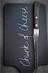 Cheese board with writing and knife