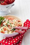 Seafood Risotto - with fish, muscles, prawns and parsley garnish; Cherry tomatoes in background