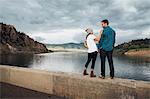 Couple standing on wall beside Dillon Reservoir, Silverthorne, Colorado, USA