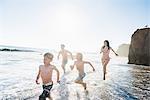Family playing on El Matador Beach, Malibu, USA