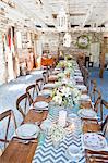 Place settings with table decorations in barn
