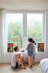 Mother sitting beside window, talking to son and daughter