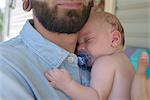 Man with sleeping baby boy on shoulder