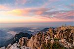 Photographer at the top of Grigna Meridionale at sunrise, Lecco, Lombardy, Italy, Europe