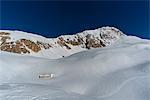 Rifugio Garibaldi in the snow with Gran Sasso in background, Campo Imperatore, Teramo province, Abruzzo, Italy, Europe