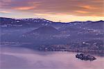 Winter sunrise on the San Giulio island at Lago d'Orta from the Madonna del Sasso sanctuary in Boleto, Orta Lake, Province of Novara, Piedmont, Italy
