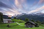 Sunrise above green meadows of Soglio, Bregaglia Valley, Maloja Region, Canton of Graubunden, Switzerland