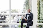 View of a black business man in a dress shirt, tie and suit coat