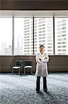 Asian woman doctor in lab coat with stethoscope.