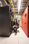 Caucasian woman technician in a large computer server farm.