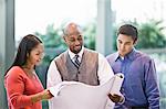 Mixed race team of business people at a table in a business centre.