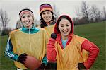 Portrait of  a group of three women friends playing American Flag Football.