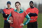 Two men and a woman, members of a team of American flag football players.