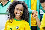 Brazilian football supporter smiling cheerfully, portrait