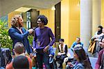 Audience watching speaker and man talking with microphone