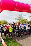 Crowd ready at charity run starting line in park