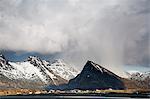 Dramatic clouds above remote, snowy mountains, Fredvang, Lofoten, Norway