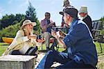 Active senior friends enjoying sunny summer picnic