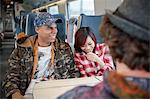 Young couple laughing on passenger train