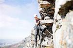 Female rock climber hanging from rock