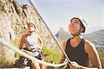 Female rock climber holding ropes