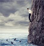 Businessman is likely to fall into the deep sea with shark. Risks and difficulties concept