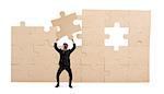 Businessman holds a piece of puzzle. Build the business concept