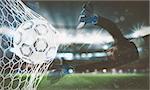 Double exposure image with a ball pierces the soccer goal at the stadium during a night match and a goalkeeper. 3D Rendering