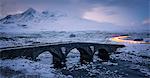 Sligachan Bridge in the snow with car light trails, Isle of Skye, Inner Hebrides, Scotland, United Kingdom, Europe