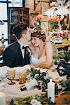 Bride and bridegroom seated at table at wedding reception