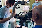 Dentist and dental nurse carrying out procedure on patient