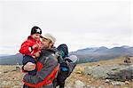 Male hiker with sons in mountain landscape, Jotunheimen National Park, Lom, Oppland, Norway