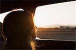 Woman in car, looking out of  window, close-up