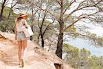 Woman walking along coastal pathway, Tossa de mar, Catalonia, Spain