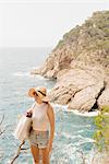 Woman along coastline, looking at view, Tossa de mar, Catalonia, Spain