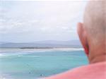 Senior man looking at coastal view, rear view, Mallacoota, Victoria, Australia