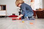 Young boy playing with toy dustpan and brush