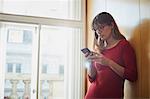 Businesswoman looking at smartphone in office