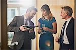 Businessman pouring champagne at office celebration