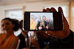 Business team raising champagne toast at office celebration, smartphone selfie close up