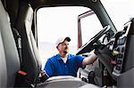 Driver getting into the cab of a  commercial truck.