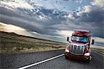 commercial truck driving through the high desert country of eastern Washington, USA