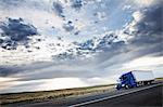 commercial truck driving through the high desert country of eastern Washington, USA