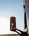 View of a Caucasian woman driver in the cab of her  commercial truck.