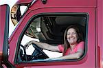 Portrait of a Caucasian woman driver and her  commercial truck.